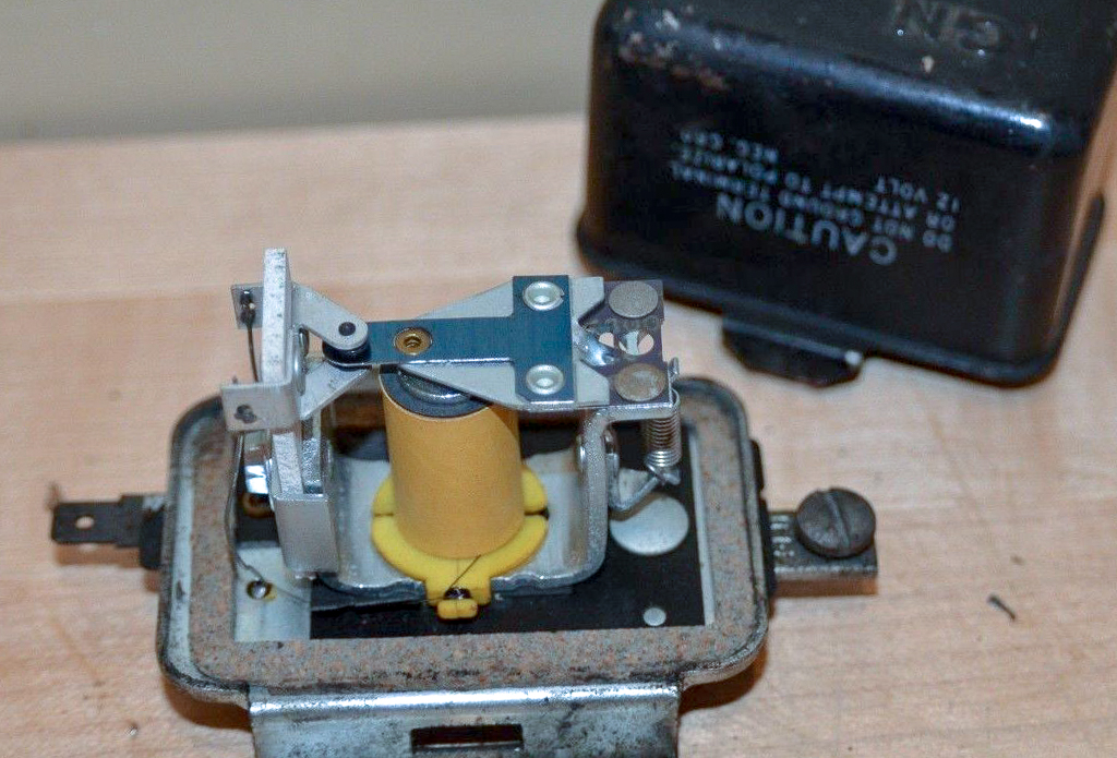 An automotive external voltage regulator with its cover removed. 