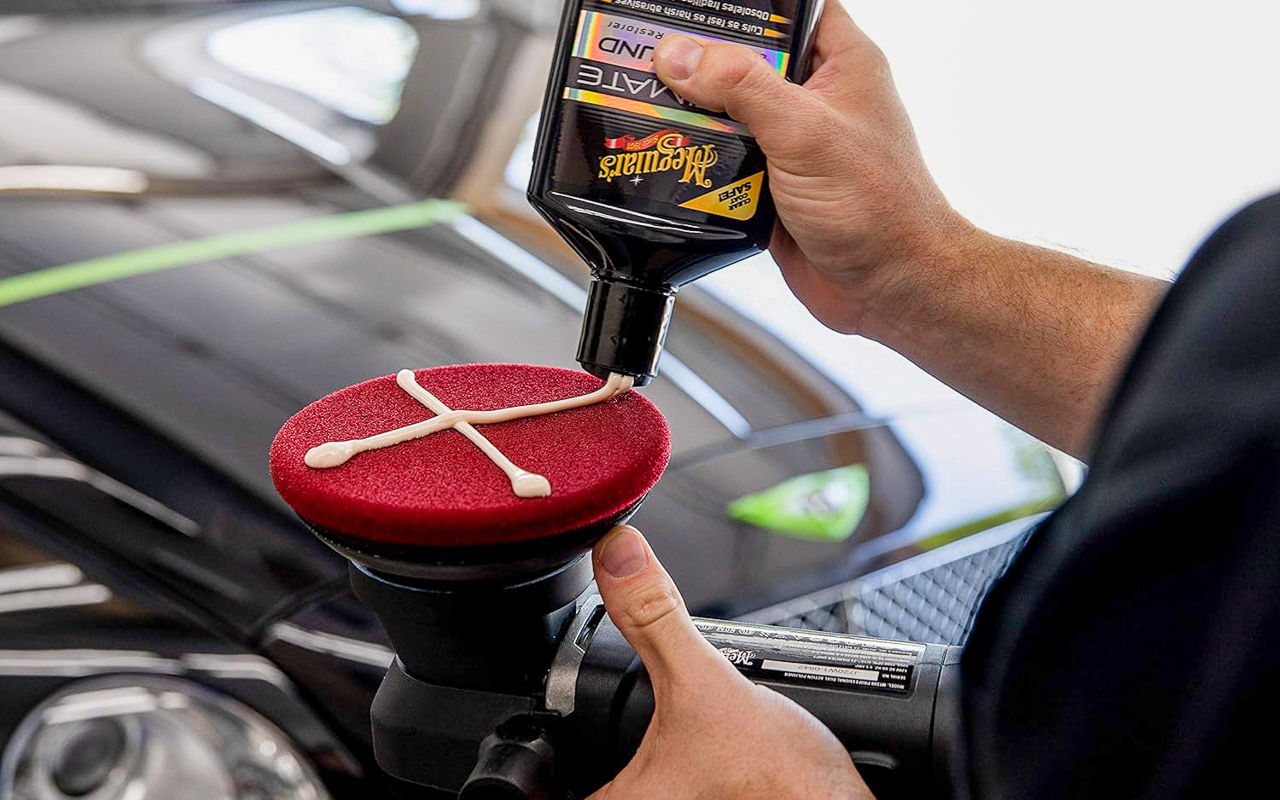 A man applying Meguiar's compound to a buffing pad. 