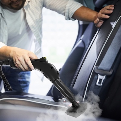 Cleaning car upholstery with a steam cleaner