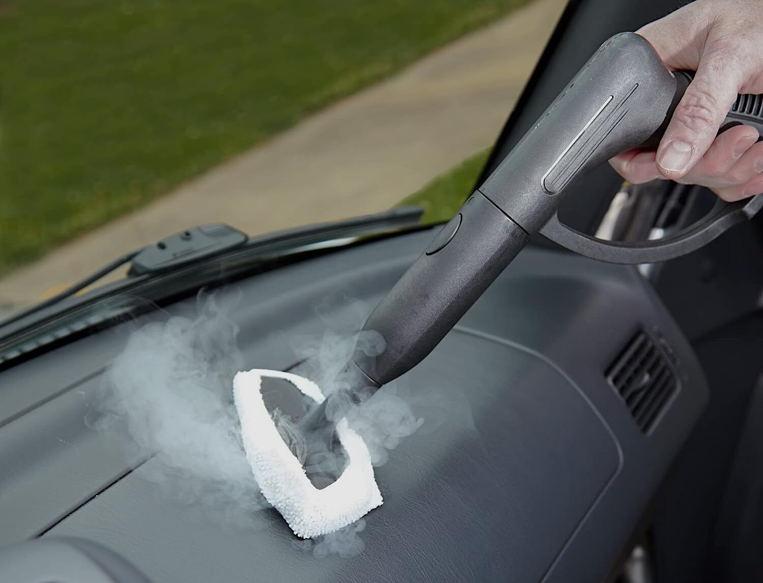 car interior cleaning, using a steamer on the dashboard