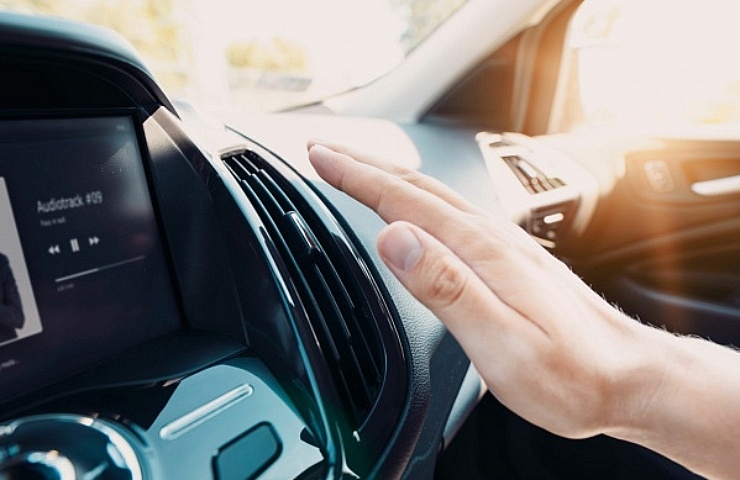 Hand checking the air conditioner in the car