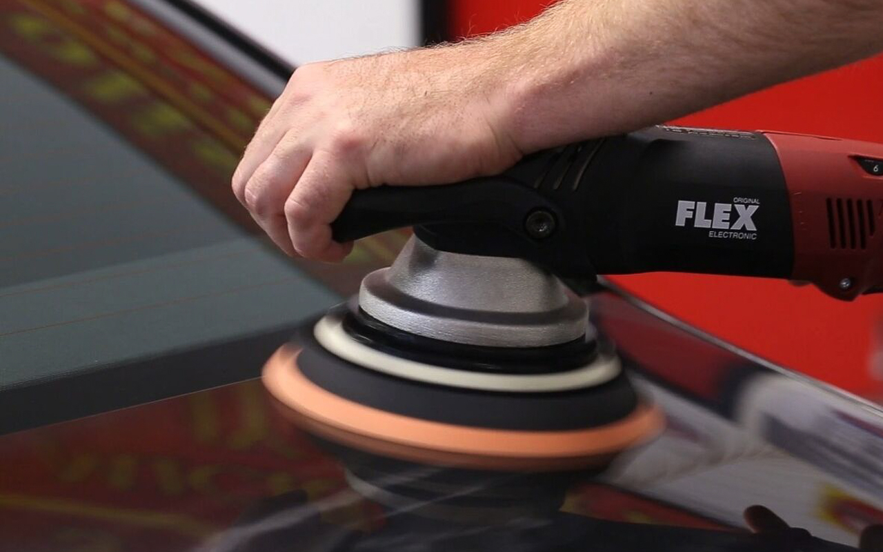 polishing a car with a power buffer