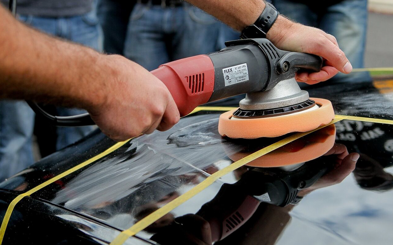 A man using a random orbital power tool 