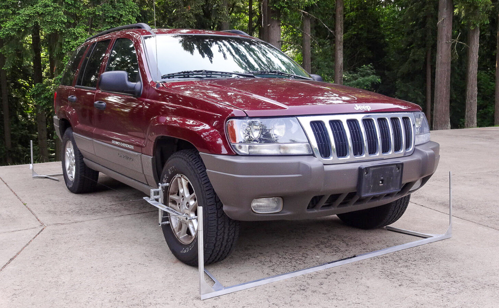 A Jeep in a driveway with a DIY home alignment tool