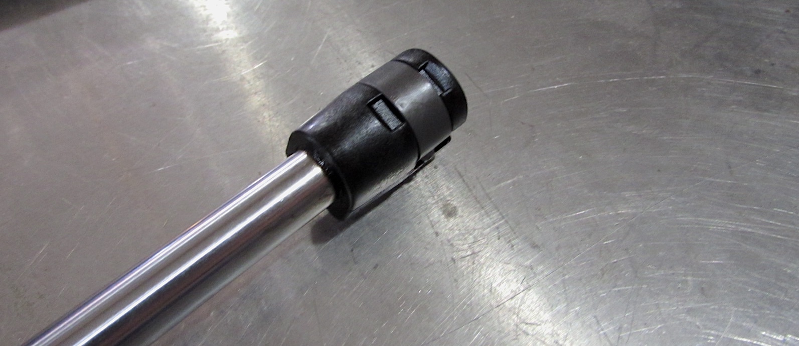 Hood strut with spring steel clamps