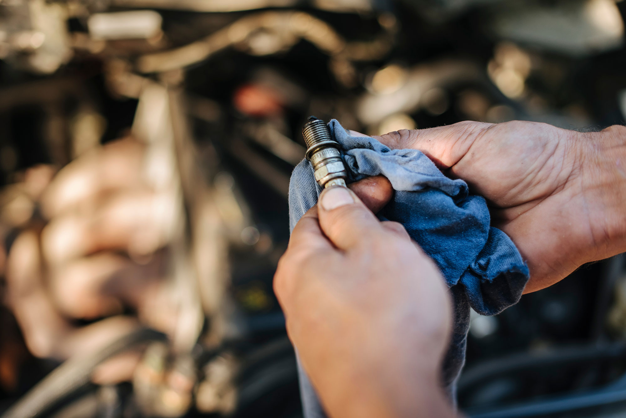 Mechanic inspects spark plugs