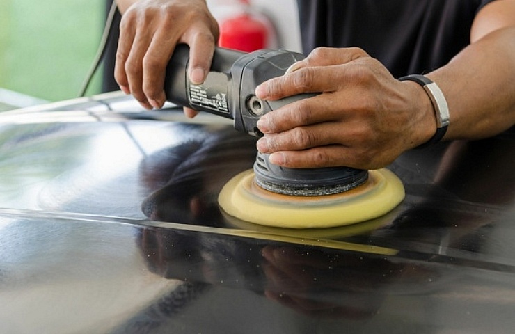 Man polishing car with a buffer