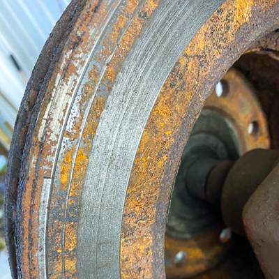 A scored and rusted brake rotor