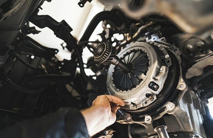 Auto mechanic installing a new clutch kit