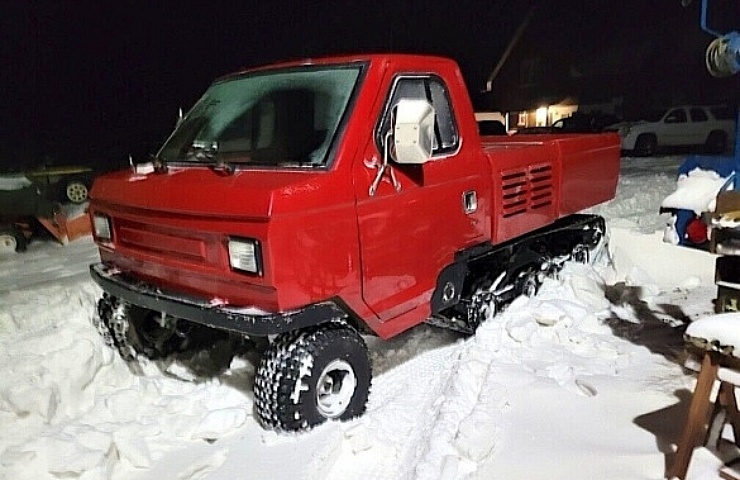 ASV Track Truck - left front profile in the snow at night