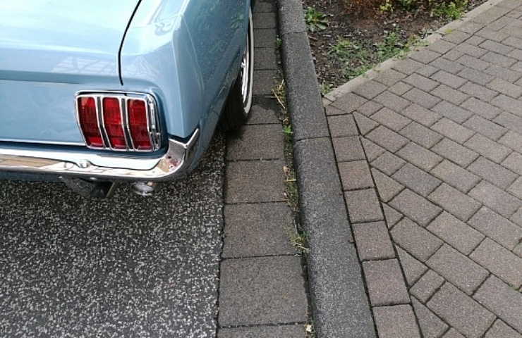 Classic blue Ford Mustang parked at the curb