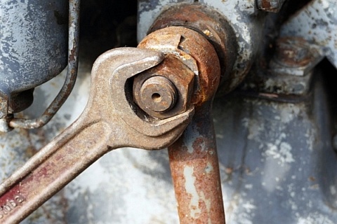 Removing a rusty nut with an open end box wrench