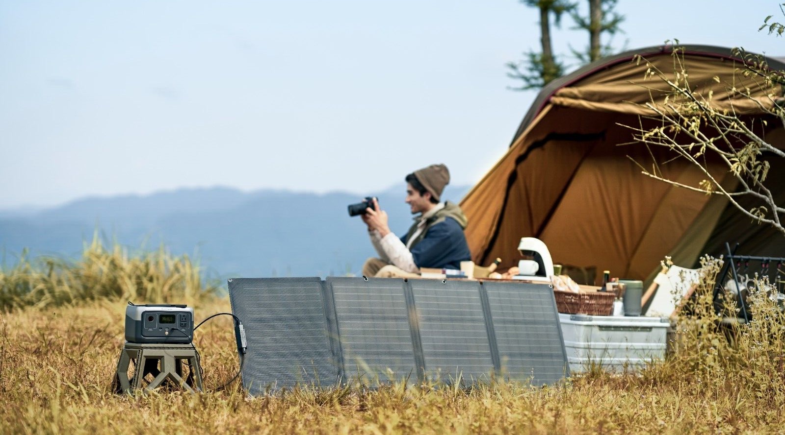 Solar panels with battery storage at photographer's campsite with tent