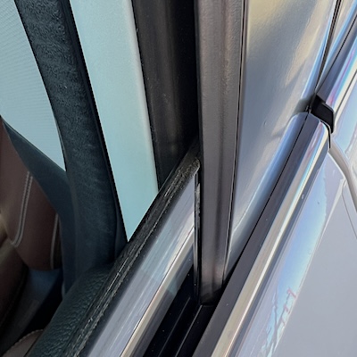 A close up view of a window in a newly lubricated track.