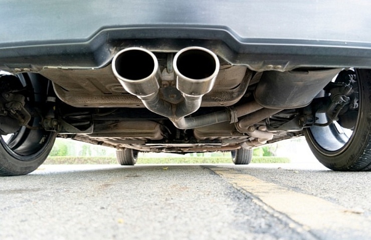 Rear view of a classic car undercarriage with a dual exhaust tip.