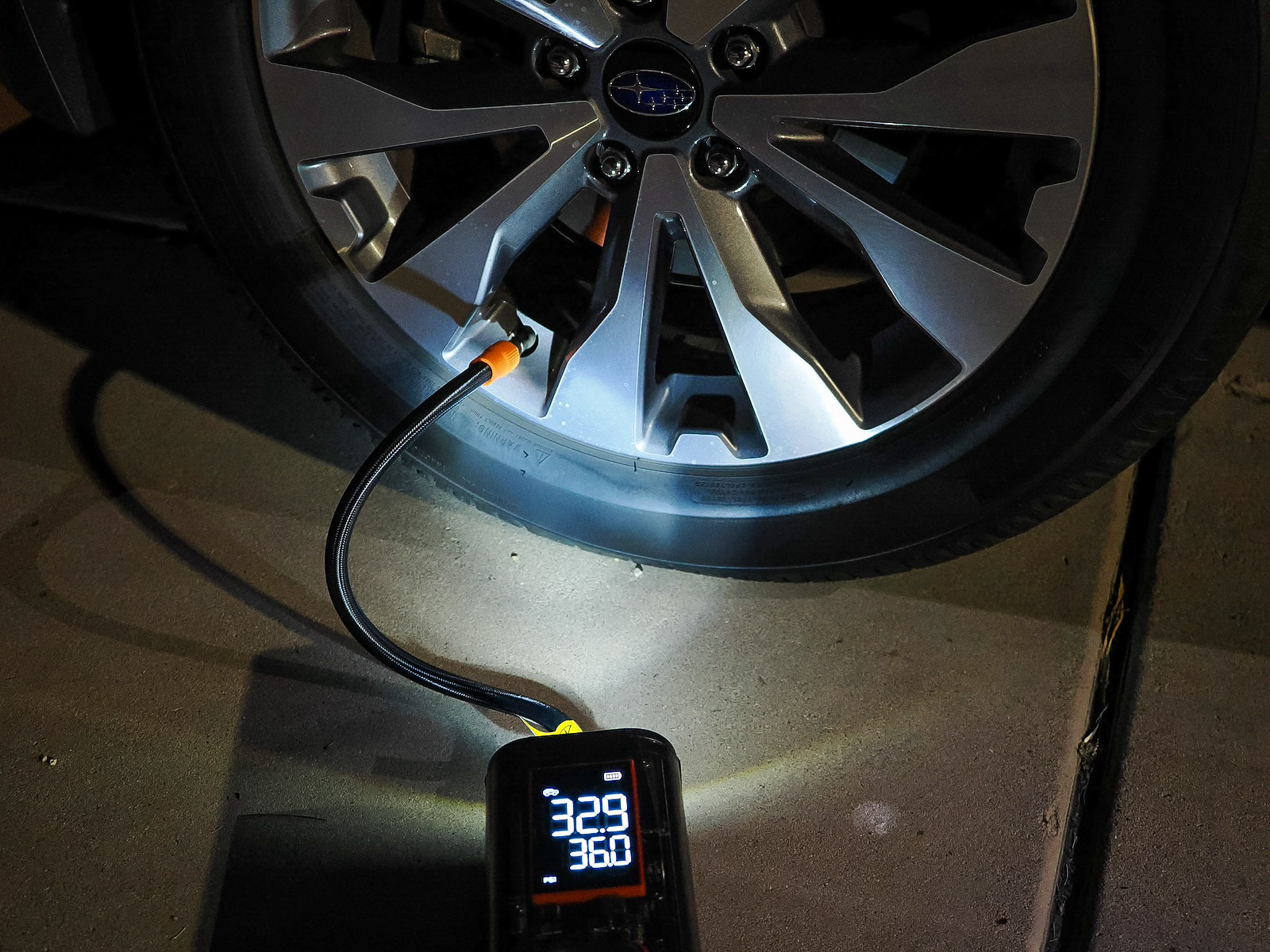 The Wolfbox portable air compressor's flashlight comes in handy when filling tires after dark.