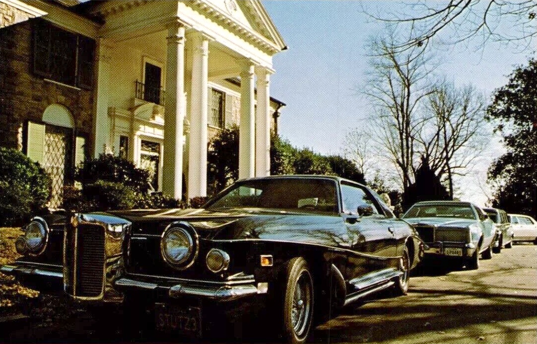 Elvis Presley's black Stutz Bearcat parked in front of his Graceland mansion.