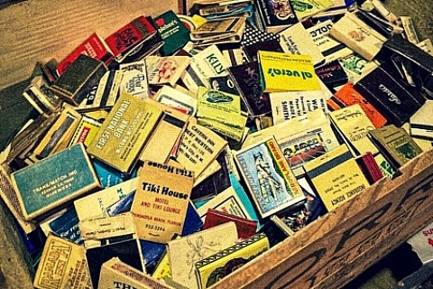 A wood crate filled with vintage matchbooks.