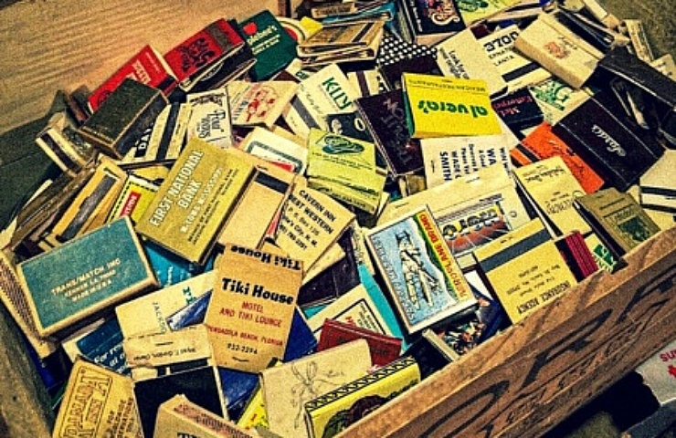 A wood crate filled with vintage matchbooks.