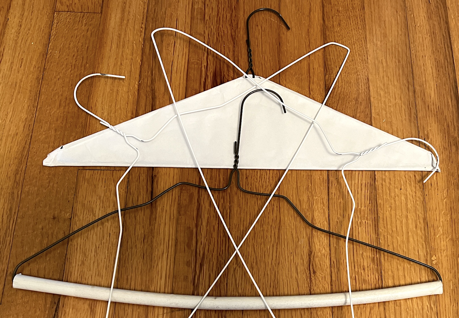 Four wire hangers on wood floor