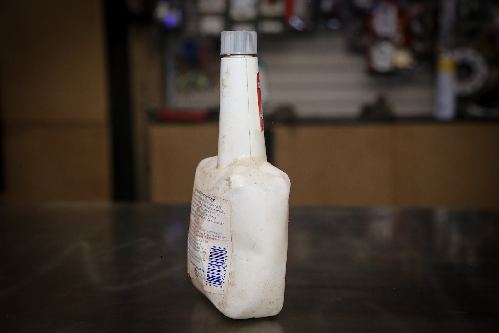 A deformed plastic bottle of octane booster.