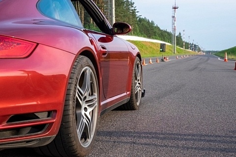 A red sports car on a race track, waiting to start.