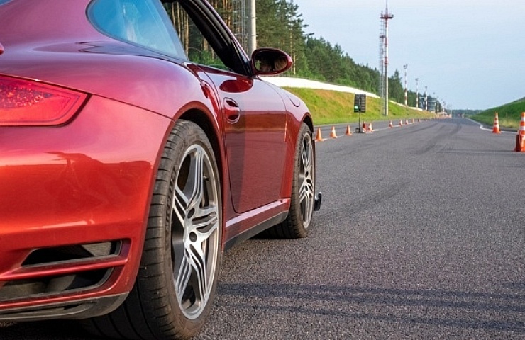 A red sports car on a race track, waiting to start.